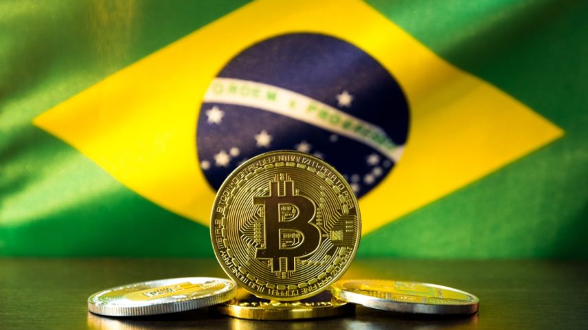 moeda de bitcoin com bandeira do brasil ao fundo (2)