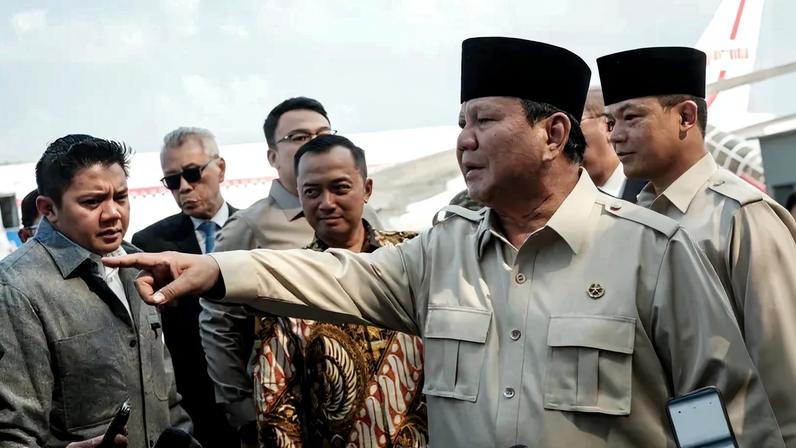 Indonesian President Prabowo Subianto gestures as he speaks to media on arrival from Egypt, where he attended the Gaza peace summit, at Halim Perdanakusuma Air Force Base in Jakarta, Indonesia, on Oct. 14, 2025.
