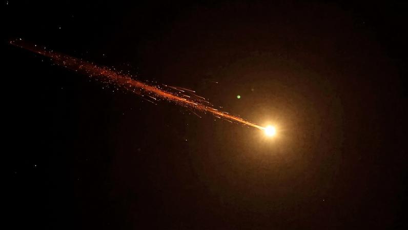 Rocket trails are seen in the sky amid a fresh barrage of Iranian missile attacks above the Israeli coastal city of Netanya, on March 17, 2026.