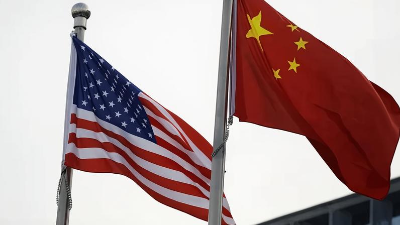 Bandeiras dos EUA e da China do lado de fora de prédio de empresa norte-americana em Pequim