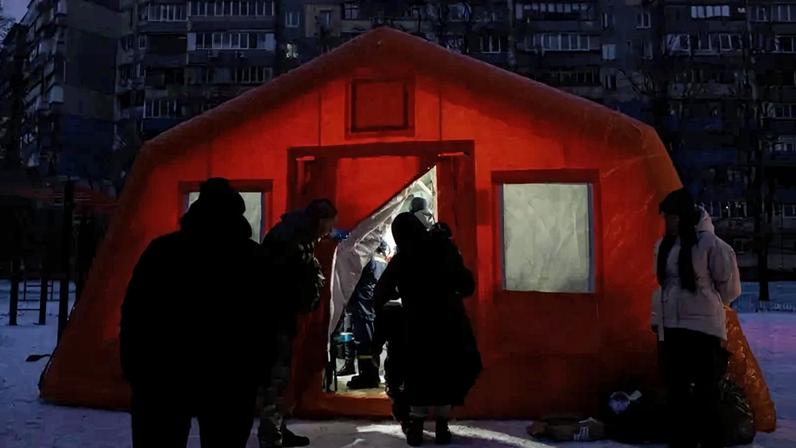 People come and go at an emergency heating tent following Russian missile and drone attacks on Ukrainian energy infrastructure.