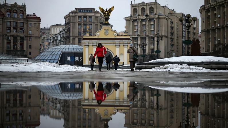 Pedestrians walk in Independence Square in Kyiv on Feb. 25.
