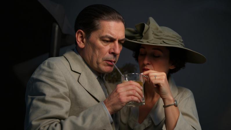 Two people drinking mint juleps at the Kentucky Derby