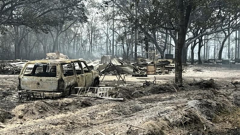 Burned vehicles and trees from the Pineland Road Fire in southeast Georgia on 22 April 2026.