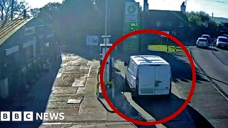 White van parked on petrol forecourt next to fuel pump
