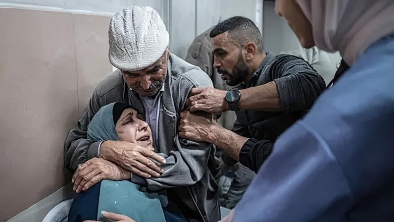 Relatives mourn at a hospital in Ramallah where the casualties were transported on Tuesday