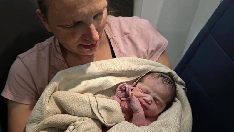 Mom holds newborn baby