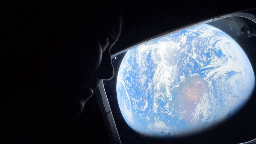 On April 4, 2026, NASA astronaut and Artemis II Commander Reid Wiseman peers out of one of the Orion spacecraft’s main cabin windows