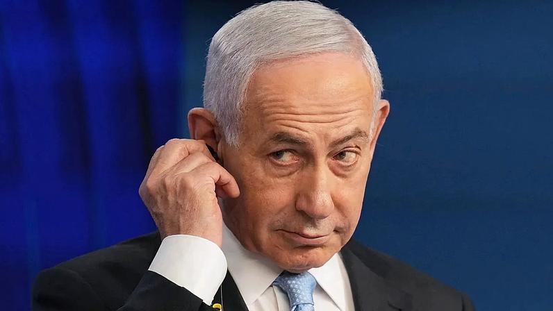 Israeli Prime Minister Benjamin Netanyahu adjusts the headphones during a joint press conference with German Chancellor Friedrich Merz in Jerusalem, Dec. 7, 2025.