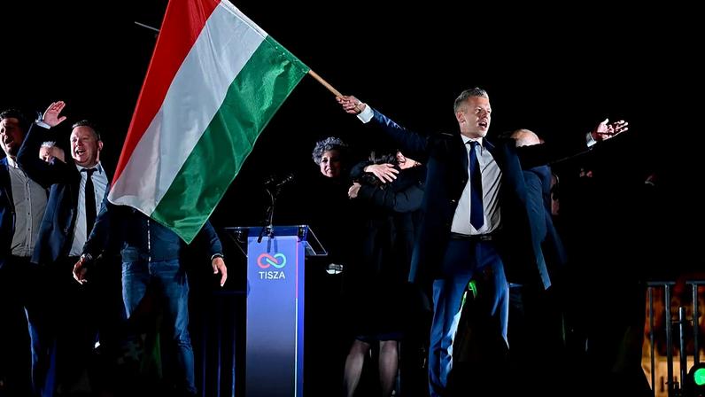 Peter Magyar, leader of the opposition Tisza party, waves the Hungarian flag following the announcement of the partial results of the parliamentary election, in Budapest.