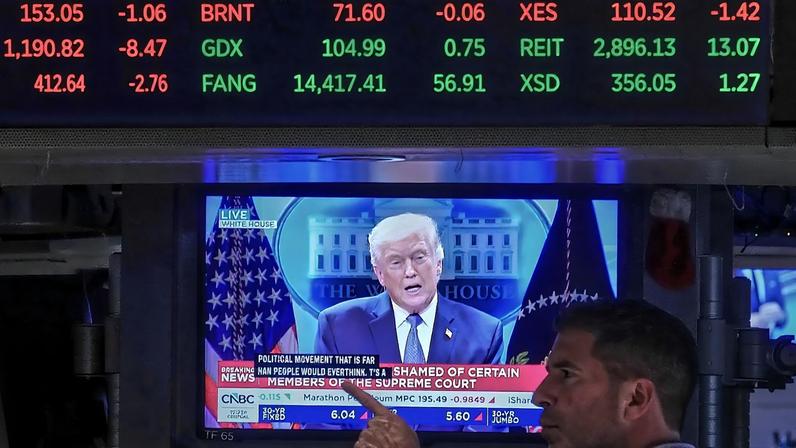 President Donald Trump appears on a trading post television screen on the floor of the New York Stock Exchange,
