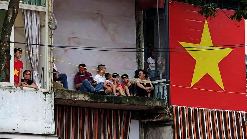 A giant Vietnamese national flag is displayed outside a balcony in the old quarter of Hanoi, 30 August, 2025