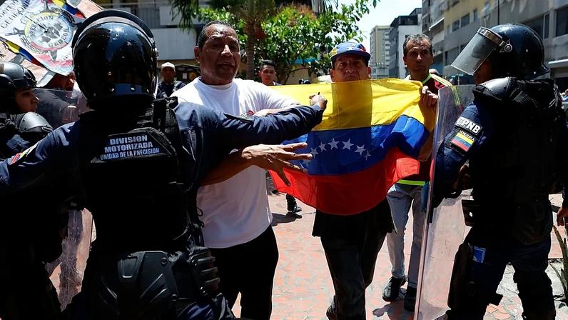 Police stop protesters who are demanding higher salaries, pensions and benefits from continuing their march in Caracas, 9 April, 2026