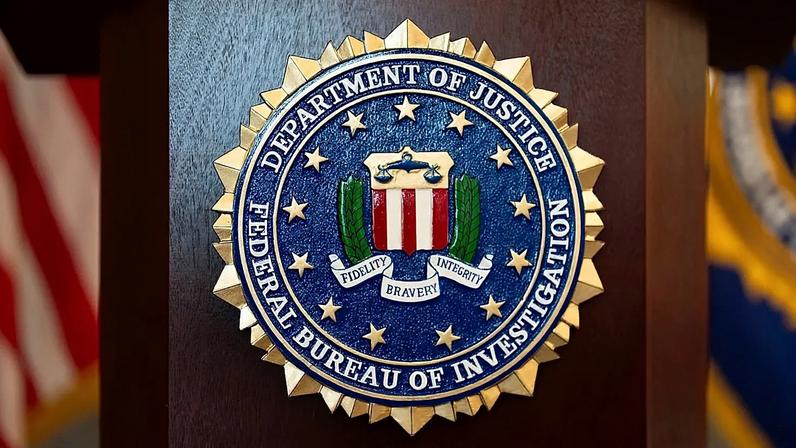 FILE - An FBI seal is displayed on a podium before a news conference at the field office in Portland, Ore., Jan. 16, 2025.