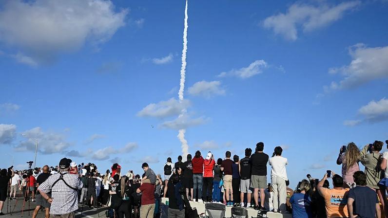 Spectators look on from the A. Max Brewer Bridge as NASA's Artemis II moon rocket lifts off on Wednesday 1 April