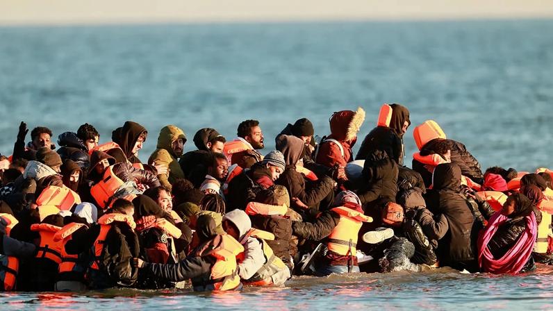 Migrants board a small boat in an attempt to reach Britain, Wednesday, April 8, 2026 in Malo-les-Bains, northern France.