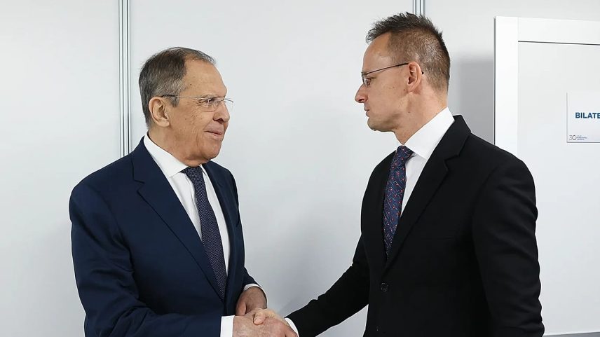 In this photo released by Russian Foreign Ministry Press Service, Russian Foreign Minister Sergey Lavrov, left, shakes hands with Hungarian Minister of Foreign Affairs and Tra
