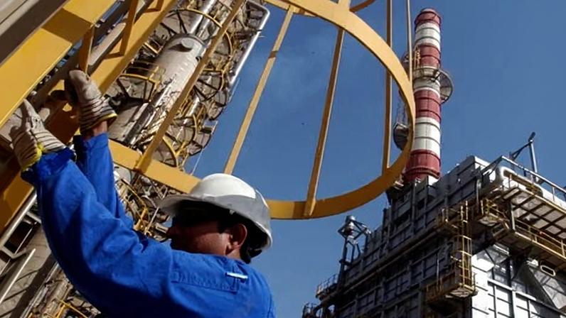 Oil technician at work at a refinery in Jebel Ali, United Arab Emirates