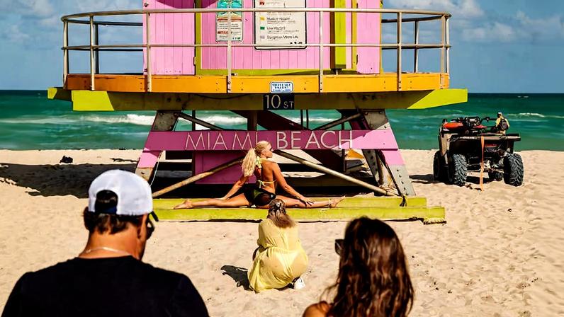 Turista posa em posto de salva-vidas em praia de Miami Beach, na Flórida