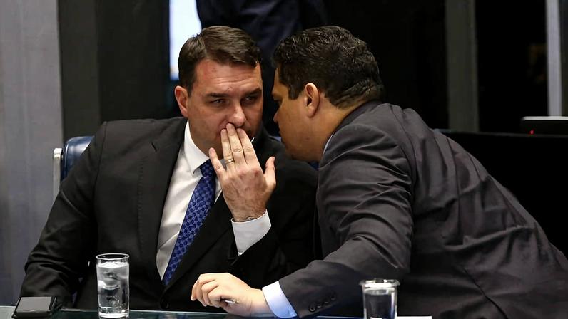O presidente do Senado, Davi Alcolumbre (União Brasil-AP), conversa com o senador Flávio Bolsonaro (PL-RJ) durante sessão