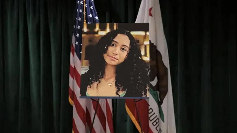 A photo of Celeste Rivas Hernandez is displayed on an easel in front of the US and California flags onstage at a media conference announcing charges against US singer David Anthony Burke, who is known professionally as D4vd.