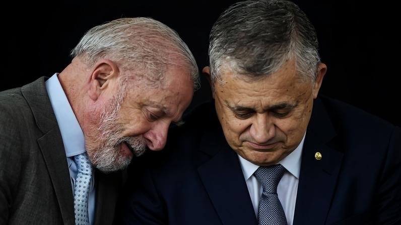 Brazilian President Luiz Inacio Lula da Silva (L) and the new Minister of the Secretariat for Institutional Relations, Jose Guimaraes, talk during Guimaraes? swearing-in ceremony at the Planalto Palace in Brasilia on April 14, 2026. (Photo by Evaristo Sa / AFP)