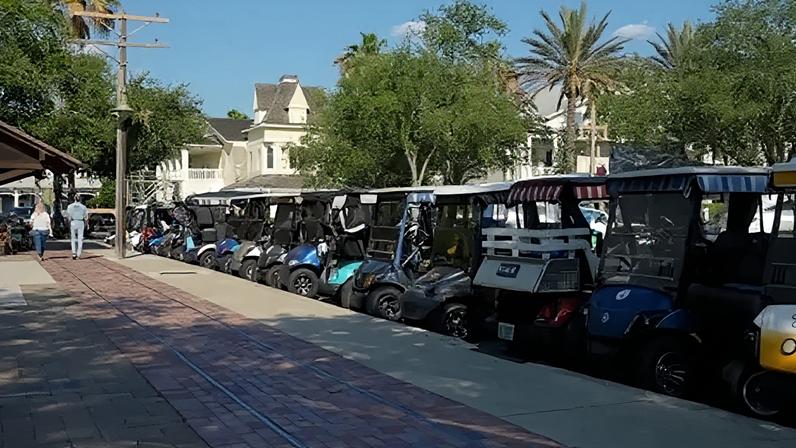 A row of colourful parked golf carts in the Villages