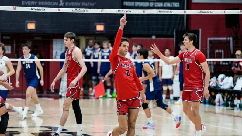 Cal State Northridge junior Jordan Lucas points an index finger to the sky as he celebrates a point.