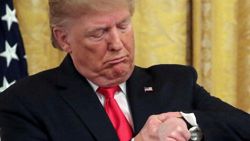 FILE PHOTO: U.S. President Donald Trump checks his watch during an event to celebrate federal judicial confirmations in the East Room of the White House in Washington, D.C., U.S., November 6, 2019. REUTERS/Jonathan Ernst/File Photo
