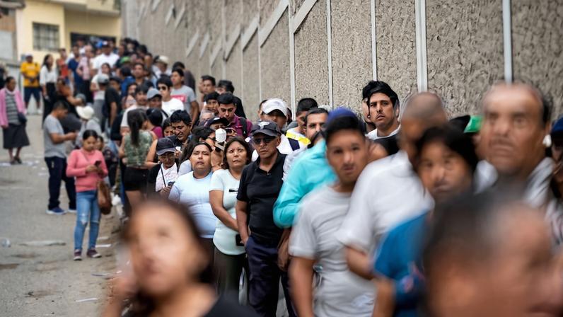 People queue to vote at a polling station after Peru's general election was extended to a second day in some precincts of the capital due to the late setup of voting tables and the absence of citizens assigned to receive voters, in Lima, Peru, April 13, 2026. REUTERS/Angela Ponce TPX IMAGES OF THE DAY