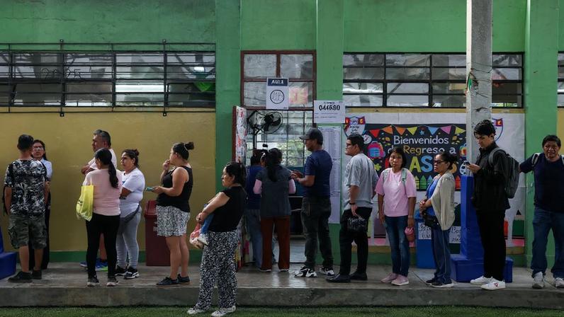 People queue to vote at a polling station after Peru's general election was extended to a second day in some precincts of the capital due to the late setup of voting tables and the absence of citizens assigned to receive voters, in Lima, Peru, April 13, 2026. REUTERS/Manuel Orbegozo