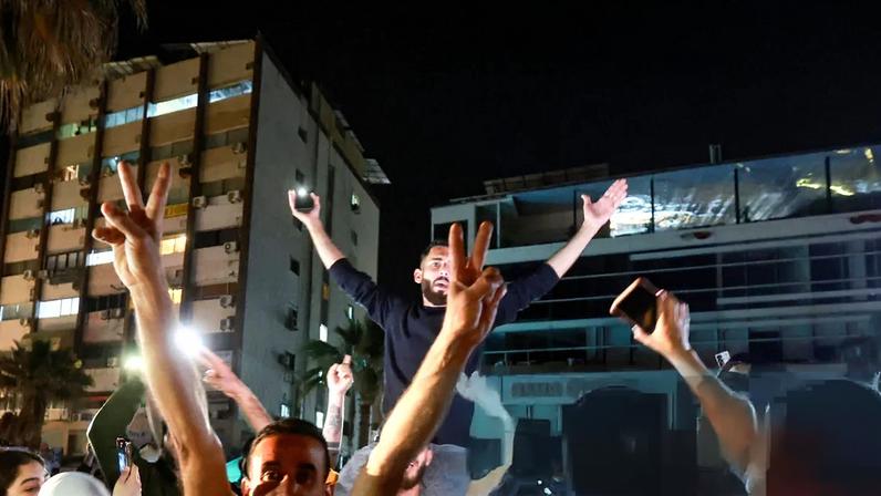 A crowd celebrates as displaced people return to their homes in Sidon, Lebanon, after a 10-day ceasefire between Lebanon and Israel went into effect. Follow live for latest updates in the Middle East crisis.