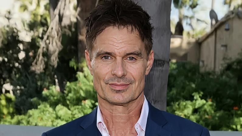 Getty Images Patrick Muldoon wearing a white open-necked shirt and blue suit jacket