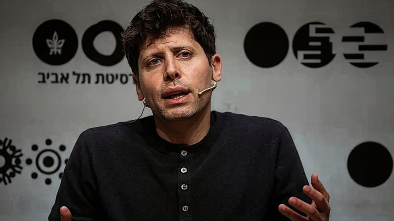Reuters OpenAI leader Sam Altman sitting on a stage, speaking and gesturing with his hands while wearing a dark grey henley sweater.