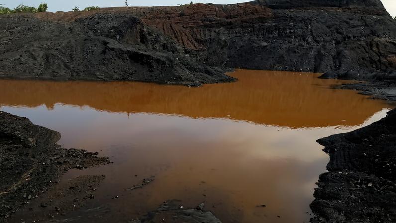 Officials from the Department of Mines, the district council and traditional leaders inspecting what the miner says is a tailings dam but which NRWA and MEPA officials found did not meet required standards. Image by Jordan Simeon Phiri for Mongabay.