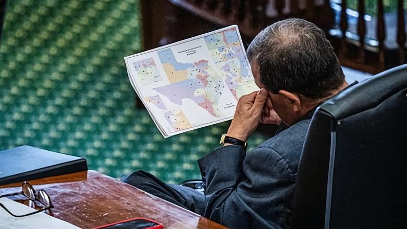 Pete Flores, a Texas senator, looks at the proposed redistricting map as the Texas senate prepares to take a vote on the redistricting bill on 22 August 2025.