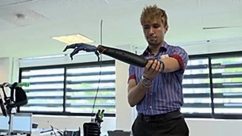 Alberto Orozco tries out a prototype robotic arm, controlled using a single muscle sensor, Guadalajara, Mexico, 19 March 2026