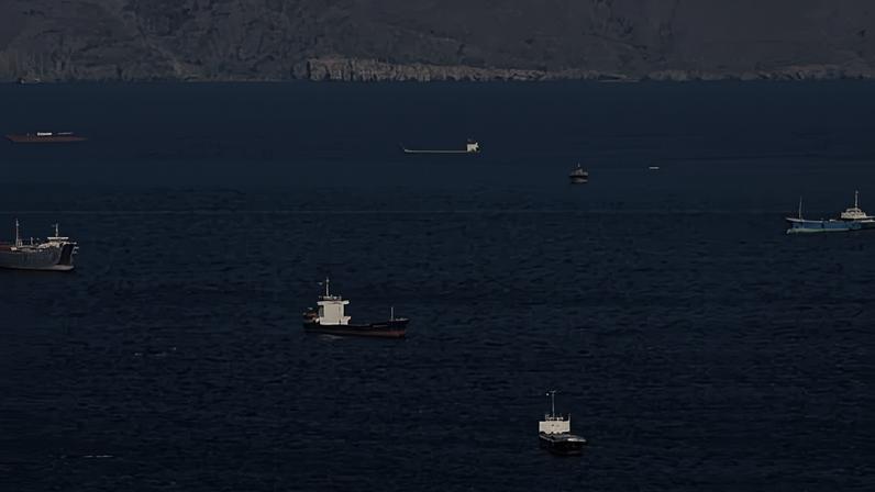 Ships and tankers in the strait of Hormuz off the coast of Musandam, Oman.