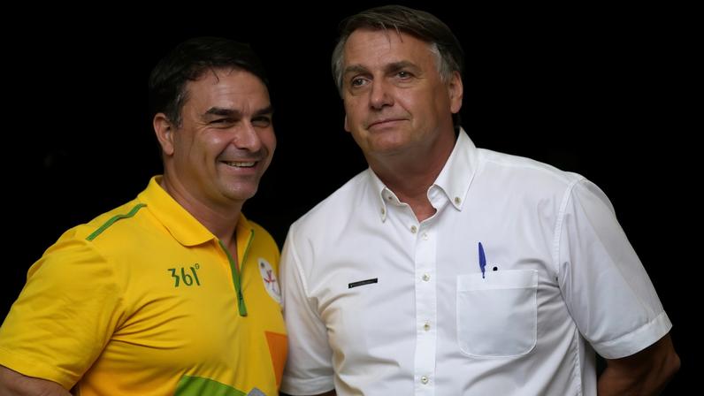 If confirmed by a supreme court justice, the sentence Jair Bolsonaro (right, pictured with his son, Flávio Bolsonaro) received for attempting a coup will be reduced from 27 years and three months to 22 years and one month.