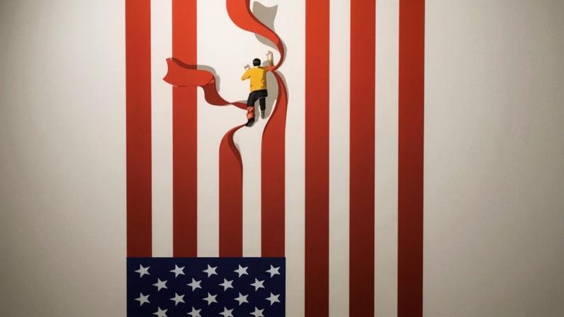 An illustration of an upright US flag with a small figure of a man halfway down it pulling down the red stripes