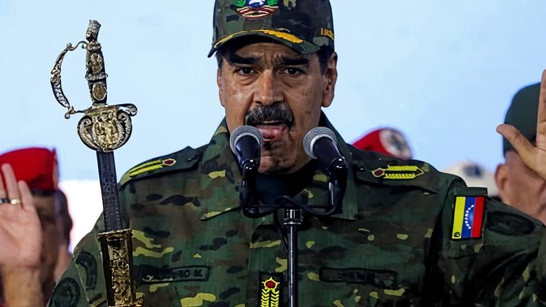 Nicolás Maduro holds Simon Bolivar's sword as he addresses a crowd during a rally against a possible escalation of US actions toward the country, at Fort Tiuna military base in Caracas in November.