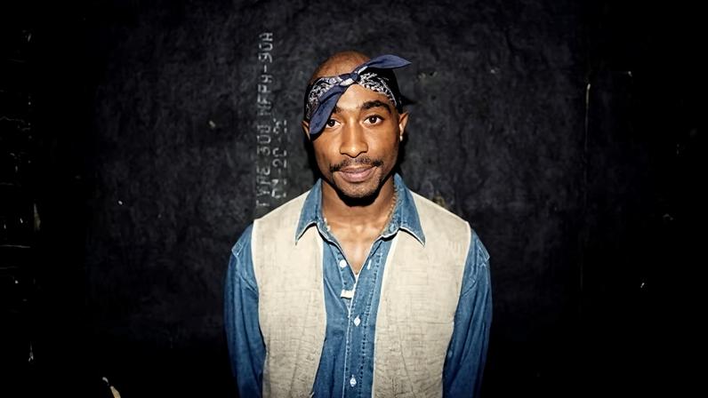 Tupac Shakur poses for photos backstage after his performance at the Regal Theater in Chicago, Illinois in March 1994.