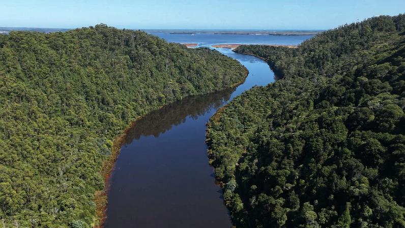 The King River enters Macquarie Harbour, where decades of mining have contributed to contaminated sediment buildup at the river’s delta.