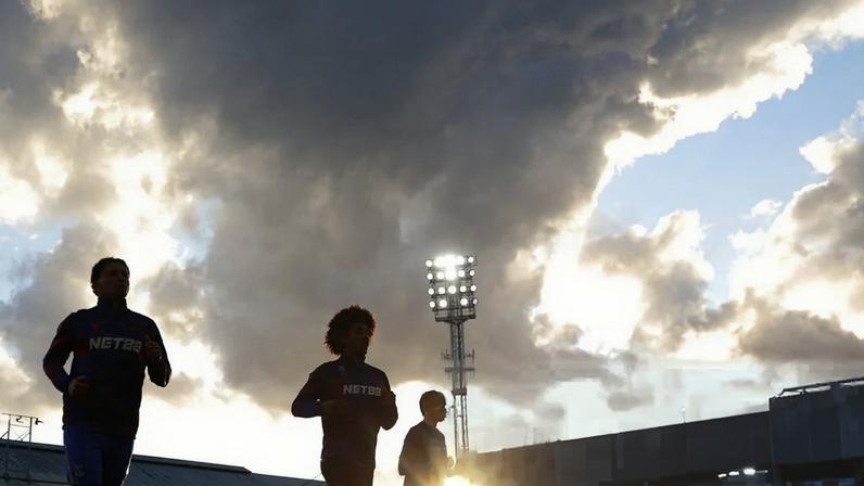 The Crystal Palace players warm up in the evening sun for the London derby against West Ham, which Tottenham will be watching closely.