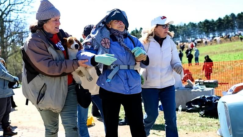 Activists help a woman who was teargassed during an attempt to gain entry to a beagle breeding and research facility on Saturday in Blue Mounds, Wisconsin.