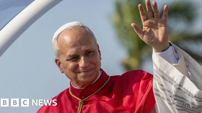 Pope Leo XIV waves during a welcome ceremony upon his arrival at 4 de Fevereiro International Airport in Luanda, Angola