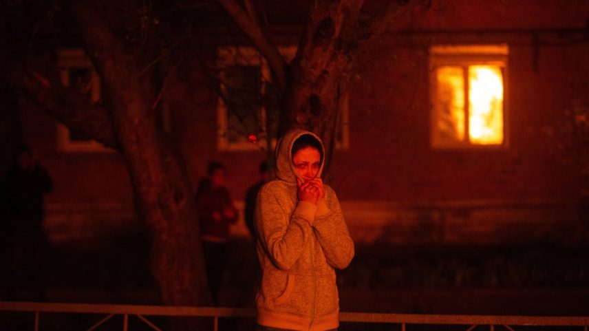 A woman stands in a residential area attacked by Russian drones in Shostka. Photograph: Anadolu/Getty Images