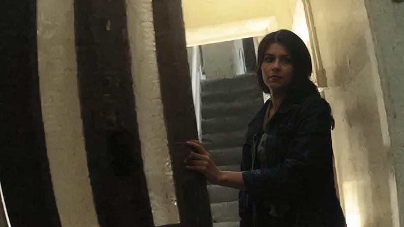 Woman opening a front door to a house