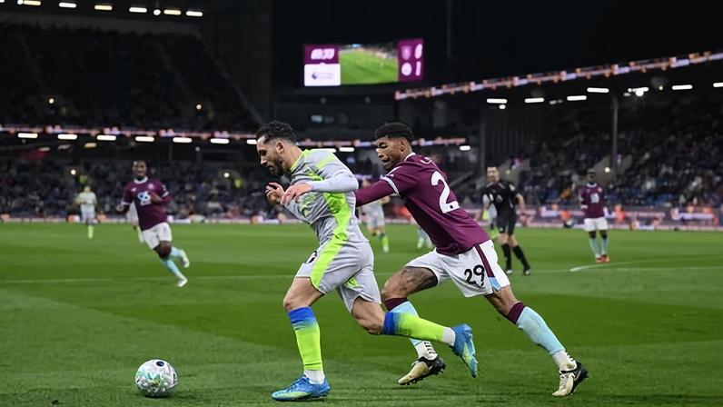 Rayan Cherki gets away from Burnley’s Josh Laurent on a night when the Manchester City forward