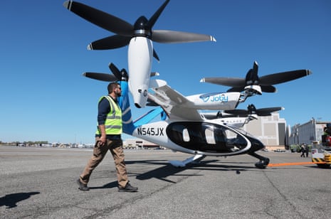 Workers and a test pilot prepare a Joby Aviation electric aircraft for takeoff from JFK airport on Monday.